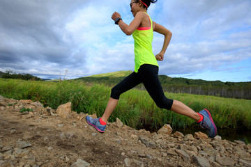 trail runner woman running on forest trail