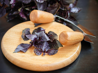 leaves of fresh purple Basil and knife on a cutting Board. Herbs. Selective focus