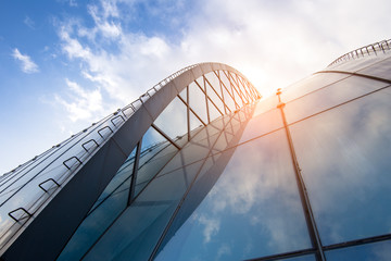 Bright outlook for business. Modern office block with sunny beautiful sky.