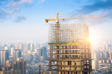Building of a skyscraper with two tower cranes