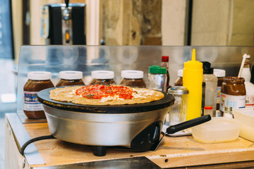 Preparing a French snack consisting of a salty crepe, also known as a 