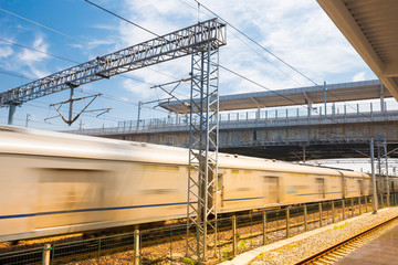 Modern high speed train at the railway station with motion blur effect