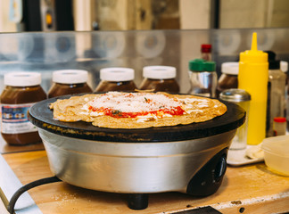 Preparing a French snack consisting of a salty crepe, also known as a 