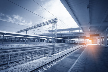 Modern high speed train at the railway station with motion blur effect