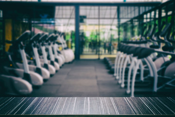 fitness facility center, gym interior, health club with sports training equipment for aerobic exercise workout and bodybuilding, blur background