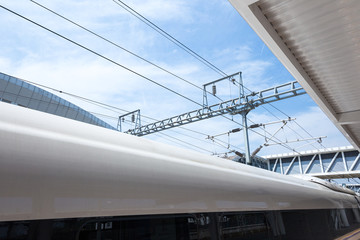 Modern high speed train at the railway station with motion blur effect