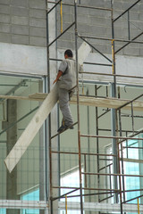 death defying construction worker on scaffolding without harness or protective gear