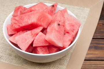 watermelon slices in plate on cloth textured background