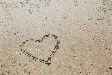 finger drawn heart love symbol on sea beach sand holiday summer concept
