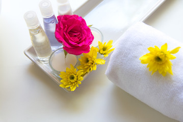 Thai Spa relax Treatments and massage with pink rose and yellow flower on wooden white.  Healthy Concept. select and soft focus