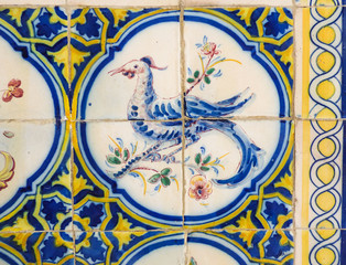 Detail of a beautiful and colorful Portuguese tile (azulejo) with drawing of a bird in Lisbon, Portugal