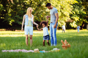 Obraz premium Happy young couple spending time with their daughter