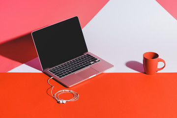 coffee, earphones and laptop