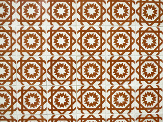 Orange and white Portuguese tiles (azulejos) with geometric pattern in Lisbon, Portugal