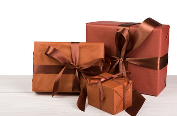 Christmas holiday gift boxes wrapped in paper on white wood