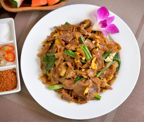 Stir fried flat noodle and pork with dark soy sauce (Thai people called Pad See Ew)