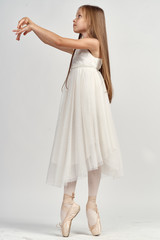 little girl in pointe shoes, ballerina, white background