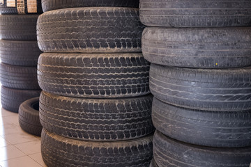 pile of car wheel in garage. vehicle tire in auto repair service. old tyre in automobile shop