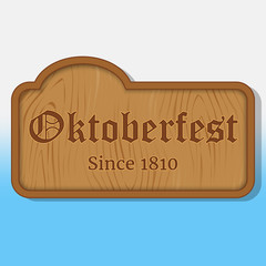Lettering Oktoberfest on a wooden nameplate. Background for beer festival Oktoberfest in cartoon style. Vector illustration. Holiday Collection.