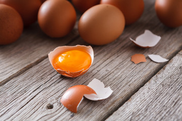 Fresh chicken brown eggs on rustic wood, organic farming concept background
