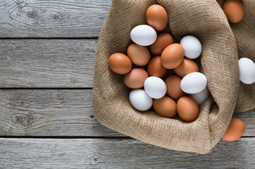 Fresh chicken brown eggs on sack, organic farming background