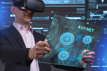Business, Technology, Internet and network concept. Young businessman working in virtual reality glasses sees the inscription: ASP.NET