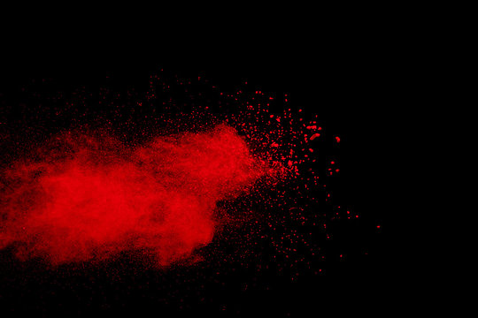 color powder explosion on black background.   Freeze motion painted Holi.
