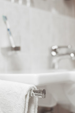 Blurred Bathroom, Focus On Towel. Bathroom In The Hotel And In The Spa Salon. Bathroom Details. Washbasin, Tooth Paste Paste,  Water Tap.