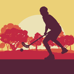 Floorball player in park with hockey stick and ball in sunset and in front of trees vector