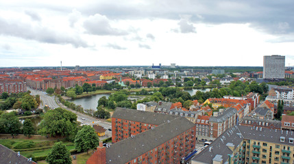 Naklejka premium Cityscape, aerial view from the observation deck at the top of the Church of Our Saviour, cloudy weather, Copenhagen, Denmark