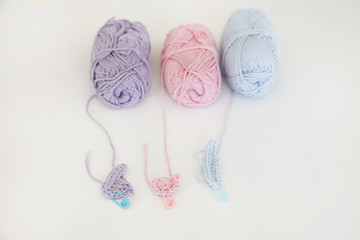 balls of wool in soft colors for knitting baby cloths