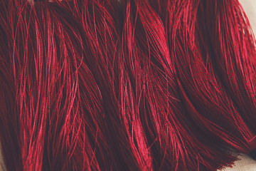 Red tassels background close up