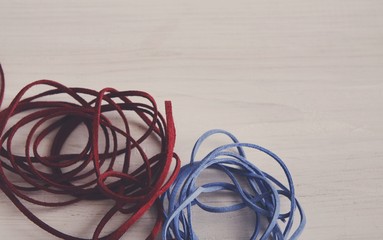 Red and blue braid on white table copy space