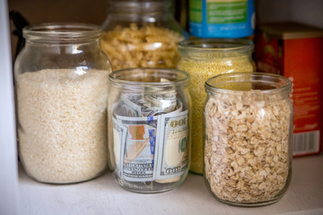 Hidden glass jars with dollars between another jars