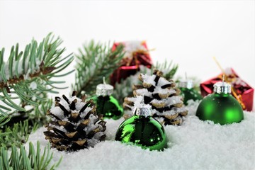 An Image of Christmas decoration with balls, snow and tree