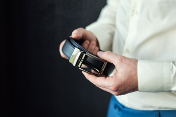 man putting on a belt, Businessman, Politician, man's style, male hands closeup, American businessman, European businessman, a businessman from Asia, People, business, fashion and clothing concept