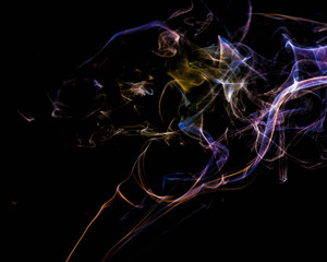 multicolored smoke dissipates in the air on an isolated black background