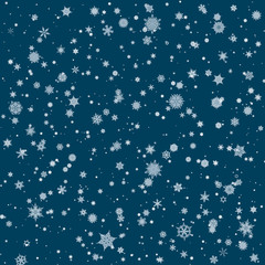 Snowflakes of different sizes and forms on blue background