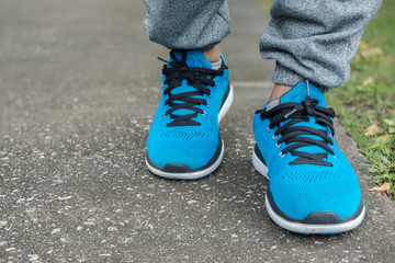 Closeup feet of man walking on raod.