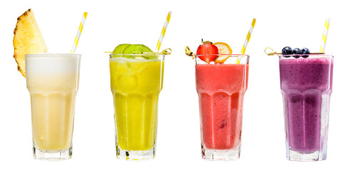 Set of classical fresh delicious smoothies in a high glasses with straws and decorated with fruits and berries on light background. Fresh natural healthy fruit and berry drinks