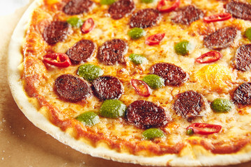 Pizza with spicy sausage