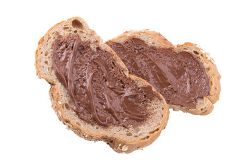 Chocolate creamy spread on brown whole wheat bread slice isolated on white background