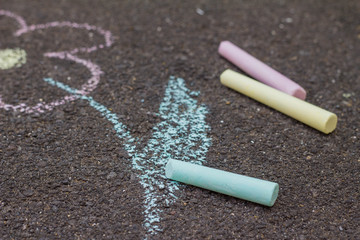 Chalk on asphalt / Colorful pieces of chalk on asphalt