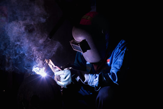 Industrial welder wear safety protective mask welding fabricated construction in factory, Welding process by Shielded Metal Arc Welding (SMAW) or Stick Welding.
