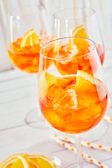 Refreshing orange spritz cocktails and glasses
