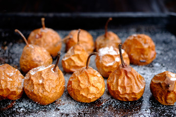 baked pears on baking tray with sugar