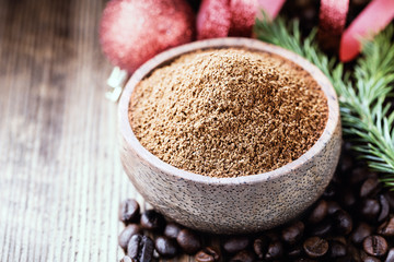 Whole and ground coffee beans  with christmas decorations. Close-up shot.