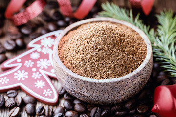 Whole and ground coffee beans  with christmas decorations.