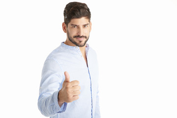 Successful young financial businessman standing against white background and giving you thumbs up.