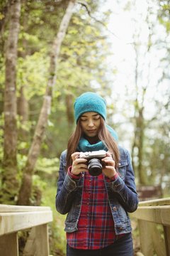 Woman looking clicked photos in vintage camera